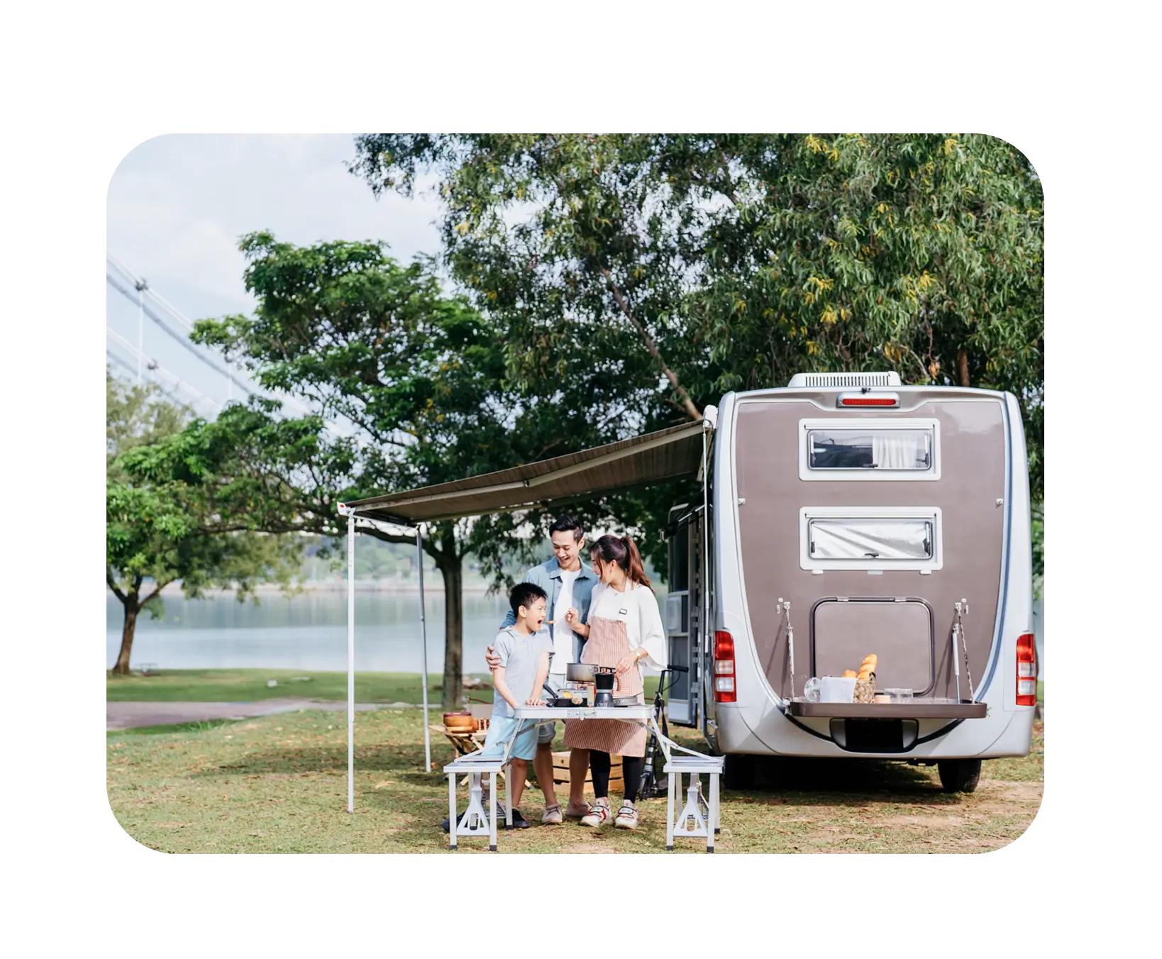 Outdoor gathering beside a caravan