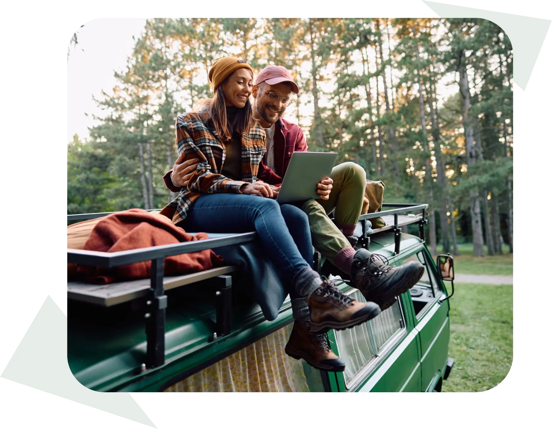 Couple sitting on van roof outdoors