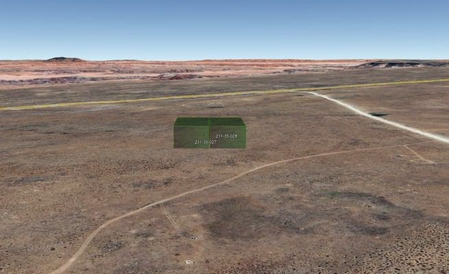 Desert landscape with digital coordinates overlay.