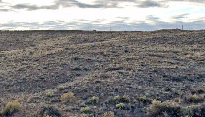 Desert landscape with cloudy sky.