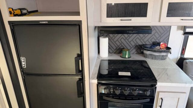 RV kitchen with stove and fridge.