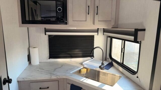 RV kitchen with sink and microwave.