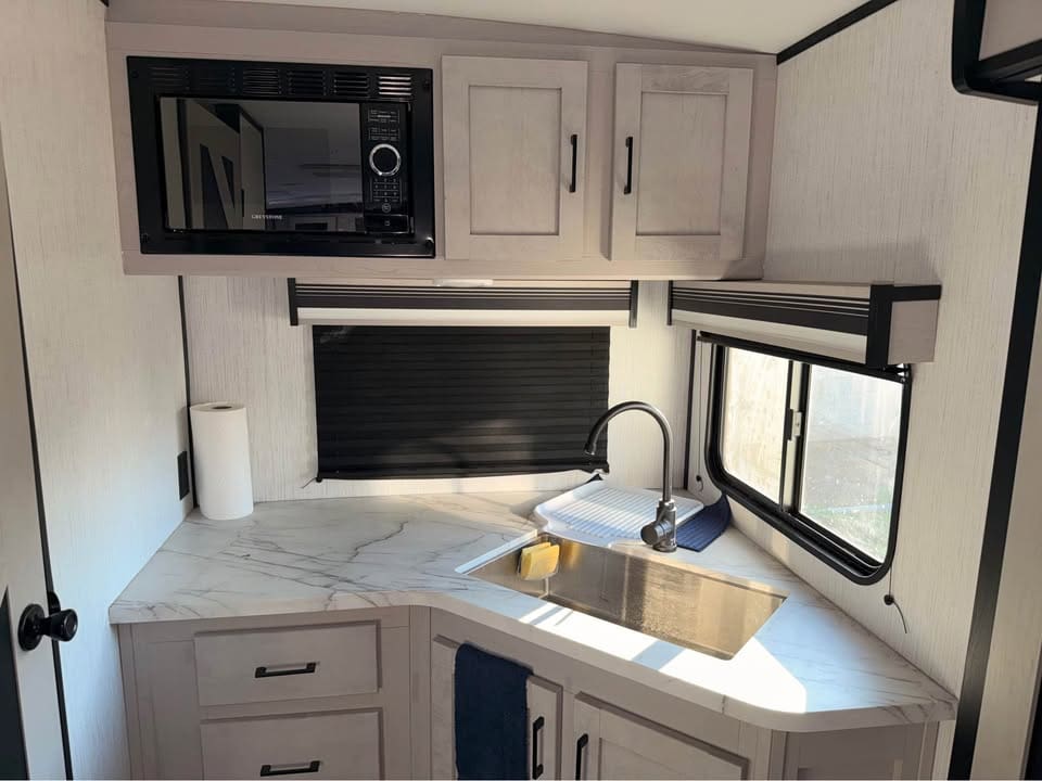 RV kitchen with sink and microwave.