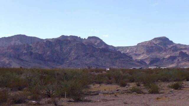 Desert landscape with distant mountain range.